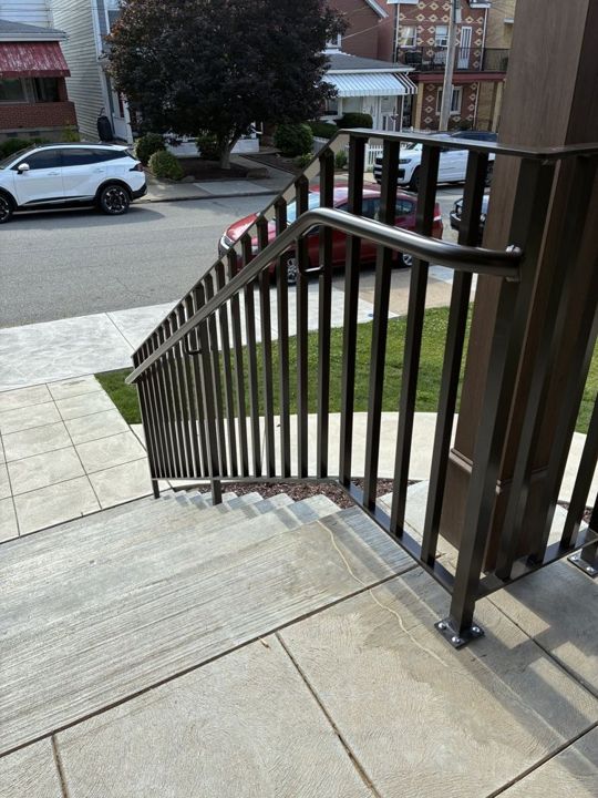 Bronze aluminum railing with a pipe handrail in Bloomfield
